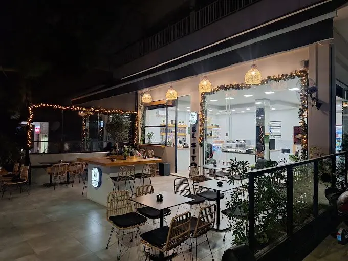 The shop at night with the string lights on